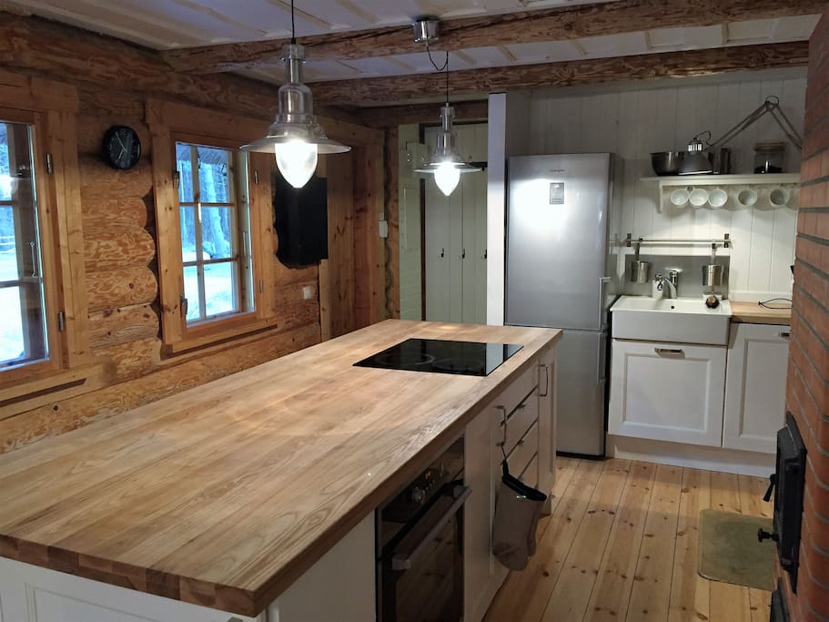 Modern kitchen with all key facitilities, wood-heated oven and microwave hidden on the right