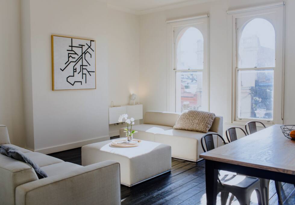 Open plan living and dining area with stunning views across Fitzroy and the city