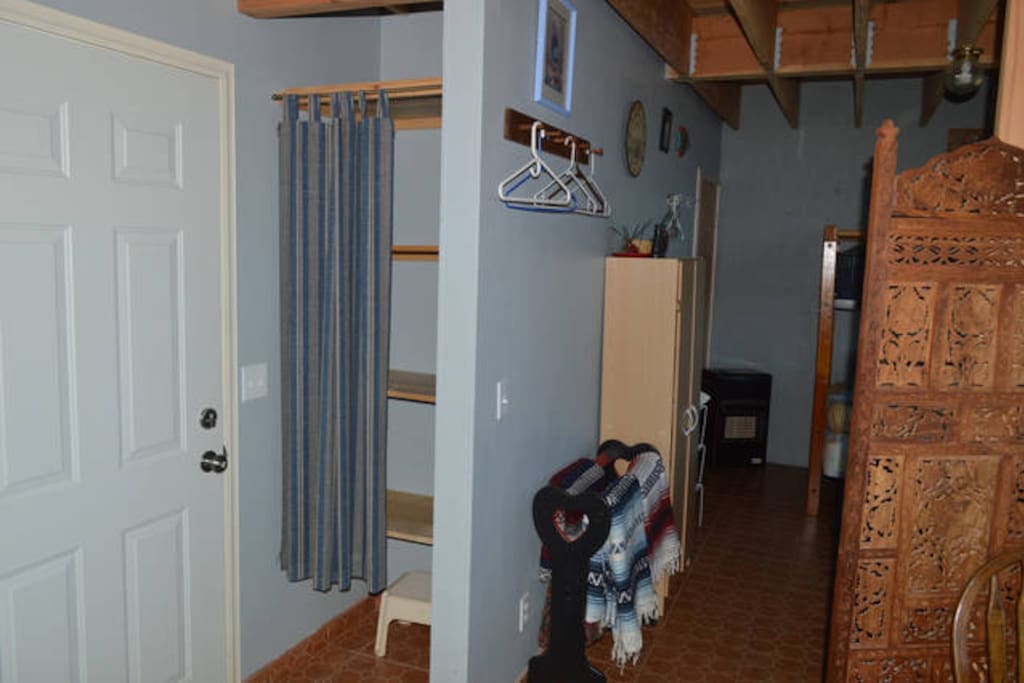 Storage area inside kitchen entry and in cabinet in bedroom area