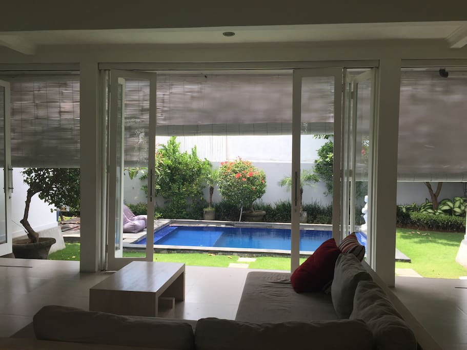View from the living room on the garden and the pool