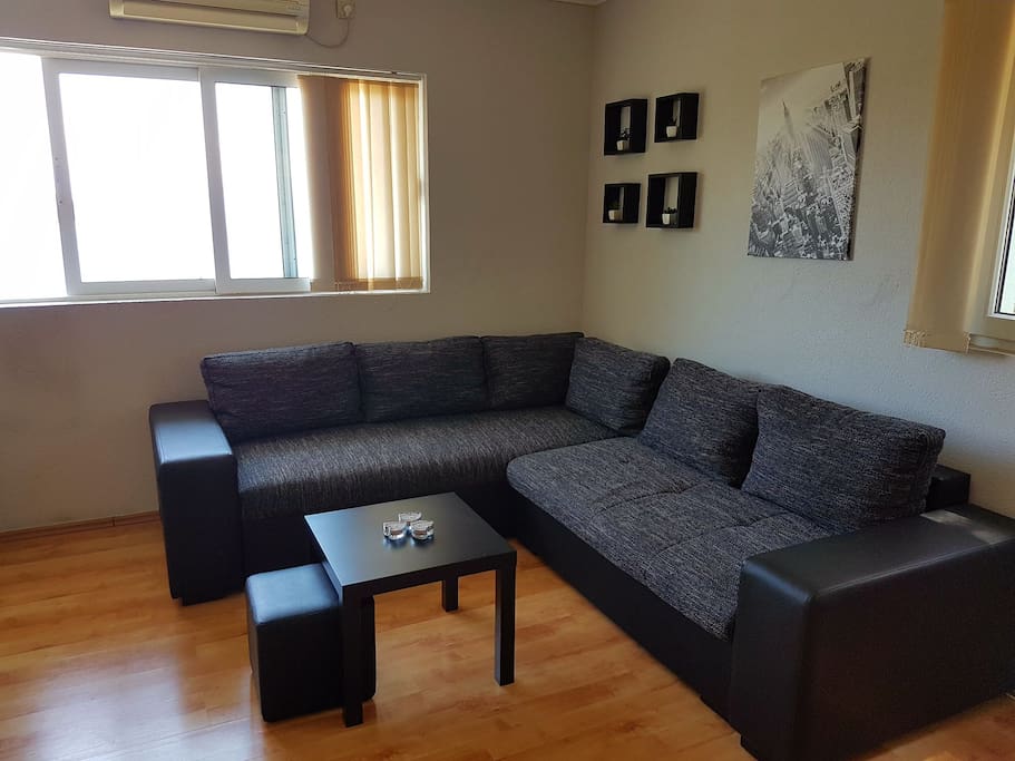Living room with big sofa and big flat screen Tv