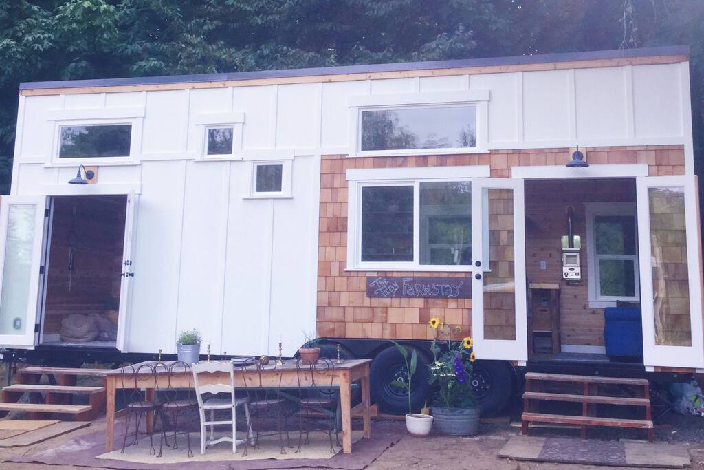 Double french doors open to view of the garden and goats. Doors on the left open from private downstairs bedroom/meditation room/office. Doors on right open from living/dining/kitchen. Deck coming soon!