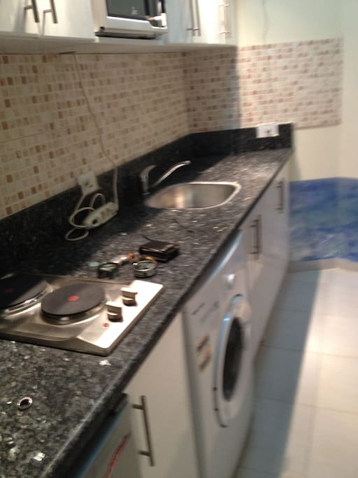 Kitchen with microwave range undercounted fridge and clothes washer