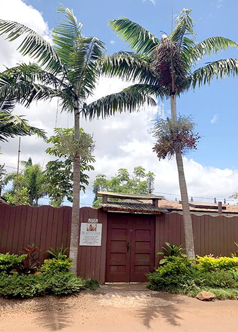 street view of the artists house entrance and fence.