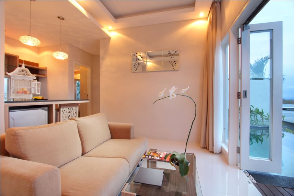 living area with 2 seater couch and kitchen set area