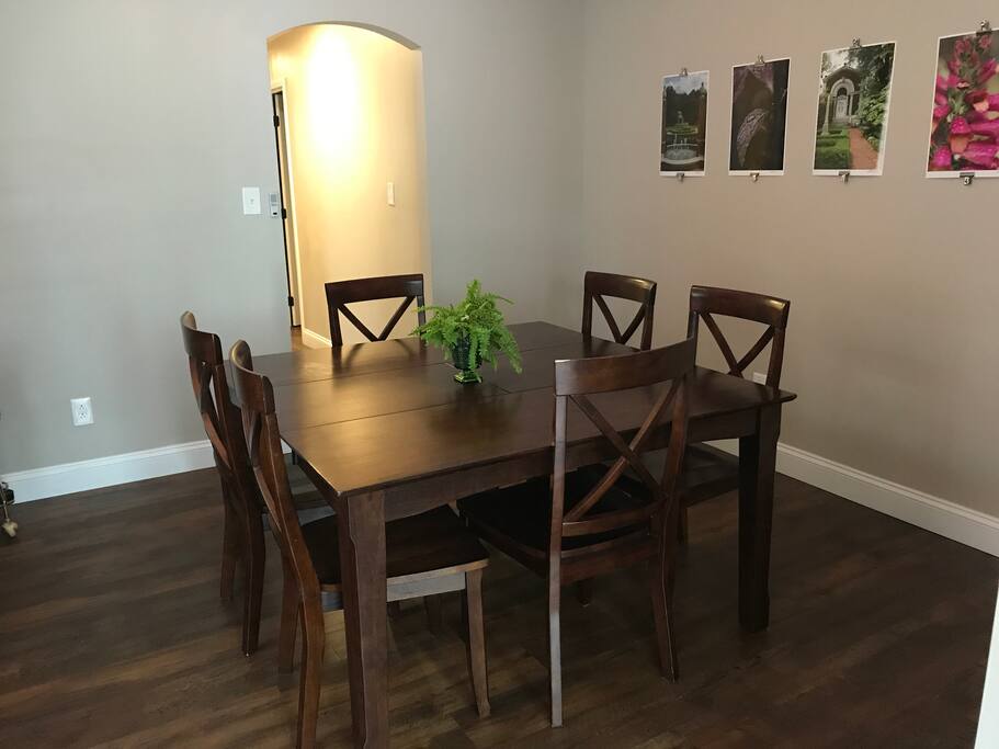 The dining rooms large table is perfect for enjoying a home cooked meal.
