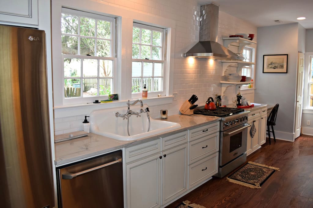 Kitchen with farmhouse sink and six burner gas range