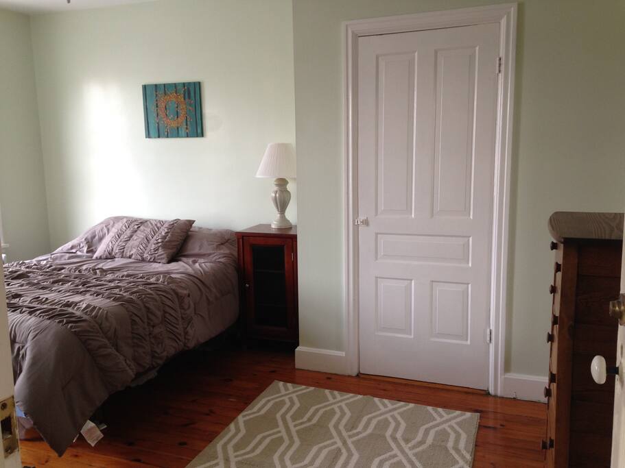 Guest Bedroom #1; double bed w/ mirror, closet, dresser, and bookshelf