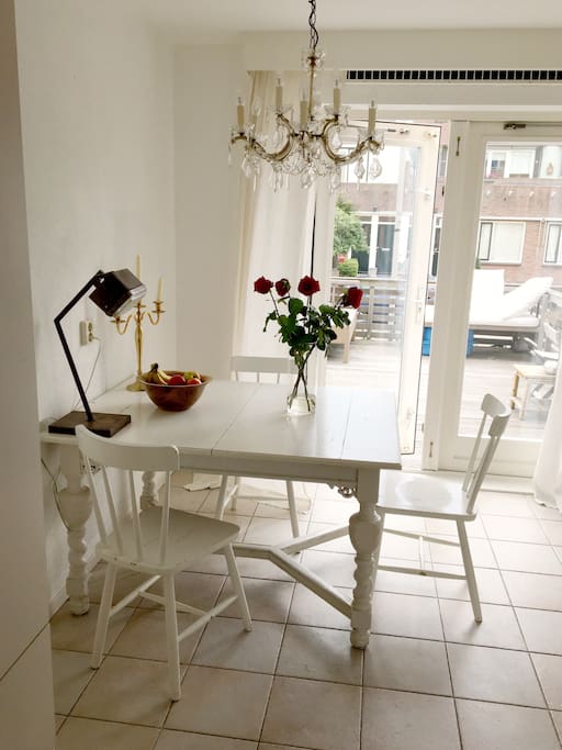 Next to the kitchen is a small room with a table