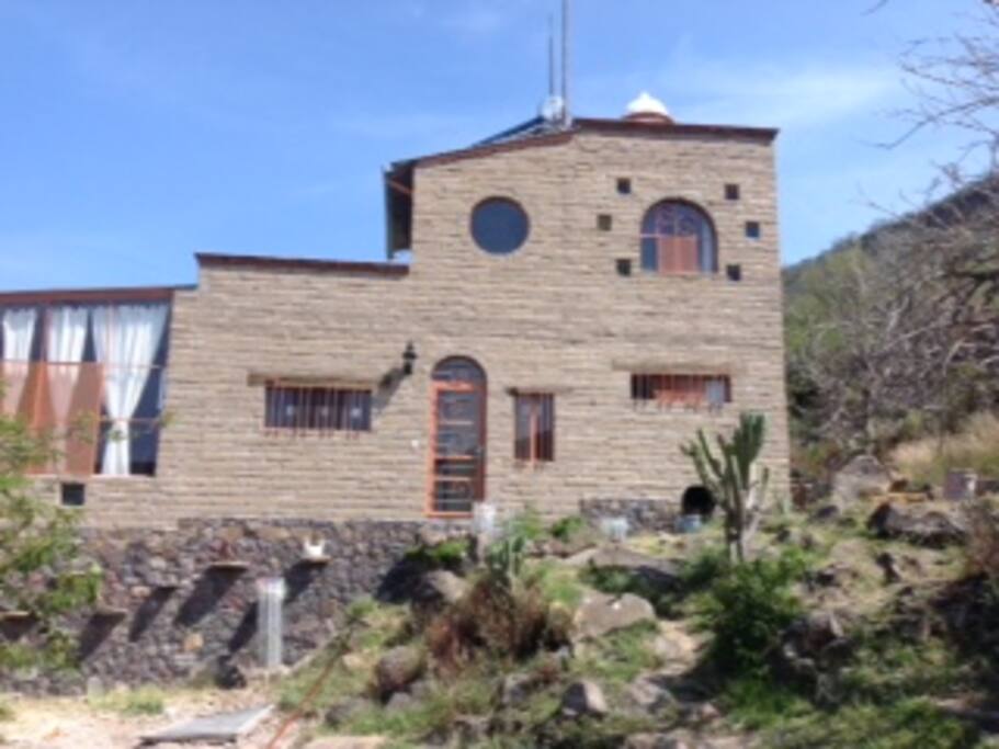 This shows the side of the house and the Entrance, The house is made of adobe brick.