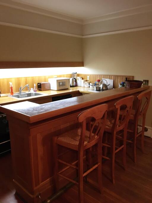 Kitchen area with appliances and bar