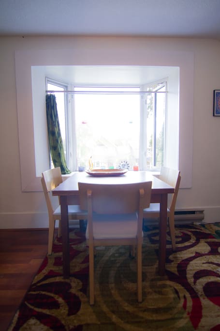 Dining table set in a south facing bay window