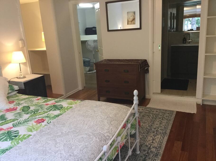 Main bedroom with ensuite shower and loo. Adjoining storage area with washing machine