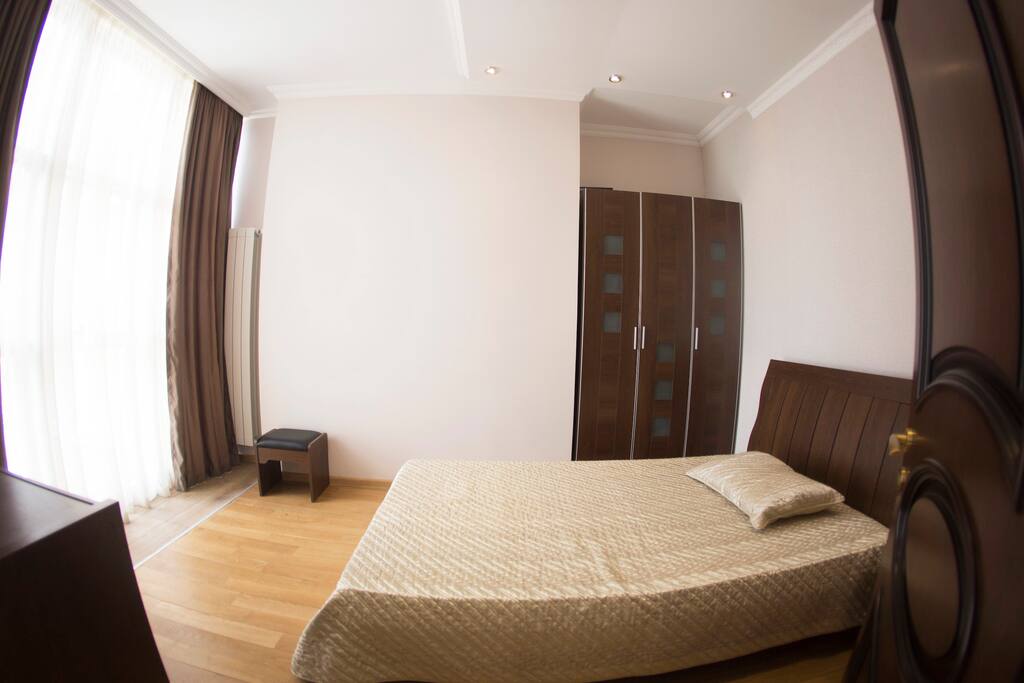 A bedroom with a double bed, closet and a Black Sea view