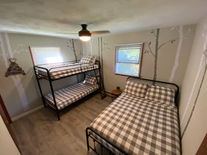 Plenty of extra room with a twin over twin bunkbed and a full-size bed in this room. 
