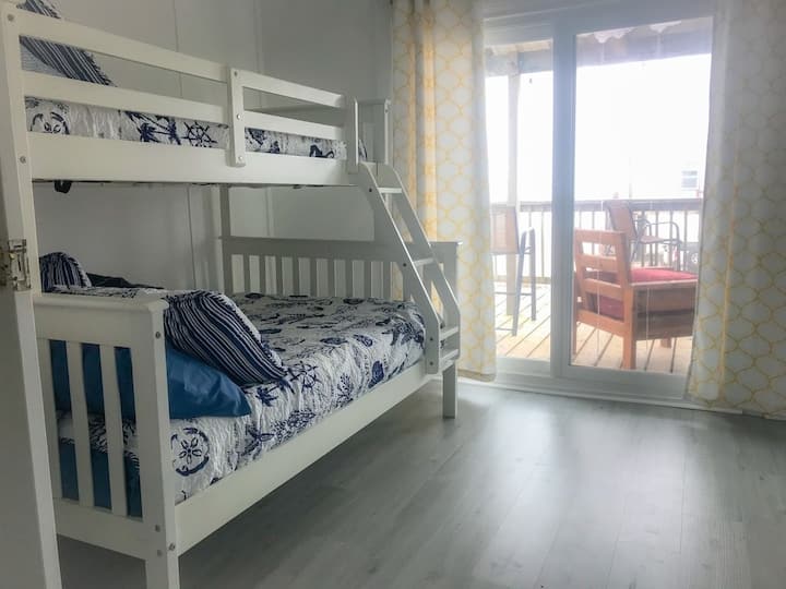 Retreat bedroom with sliding door to separate from the main bedroom. Has  own access from the living area. Twin over double bunk. Access to the deck and beach views