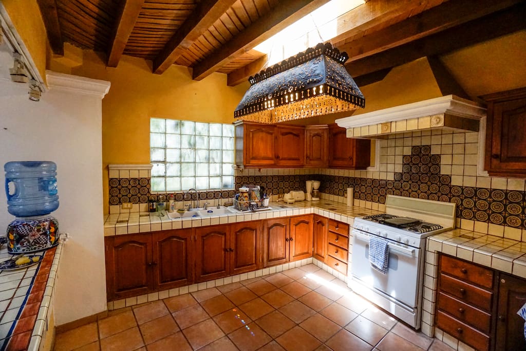 Large kitchen with reverse osmosis water filter in the sink.