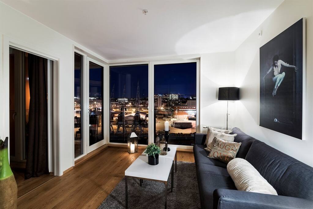 The living room at night, with the view from the large windows.