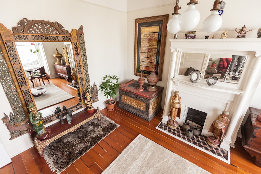 Family room with original hardwood floors, Victorian fixtures and Asian antiques from Burma and Indonesia