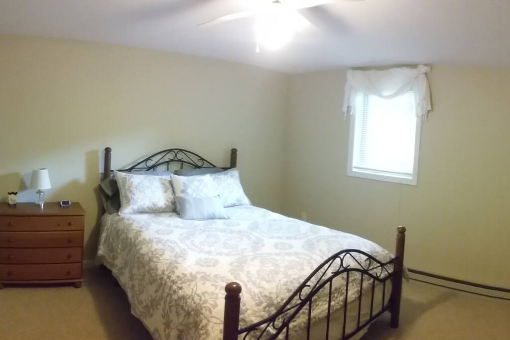 Queen Bedroom, cozy bed, ceiling fan and plenty of drawer space