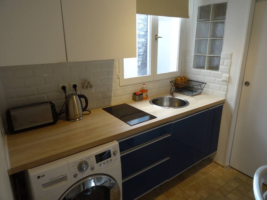 View of the kitchen from the doorway into the main room. Window looks out over the courtyard