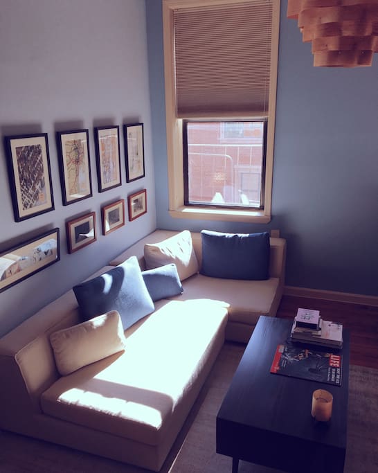 Tranquil blues and earth tones make lounging on this living room sofa truly relaxing.