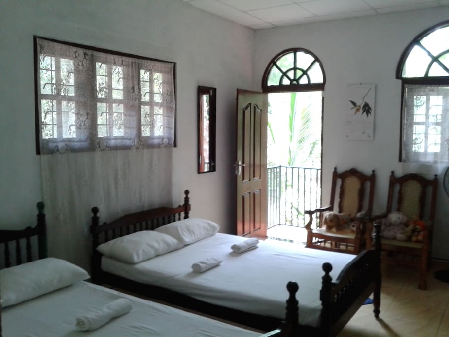 large room with 2 double beds and lovely balcony