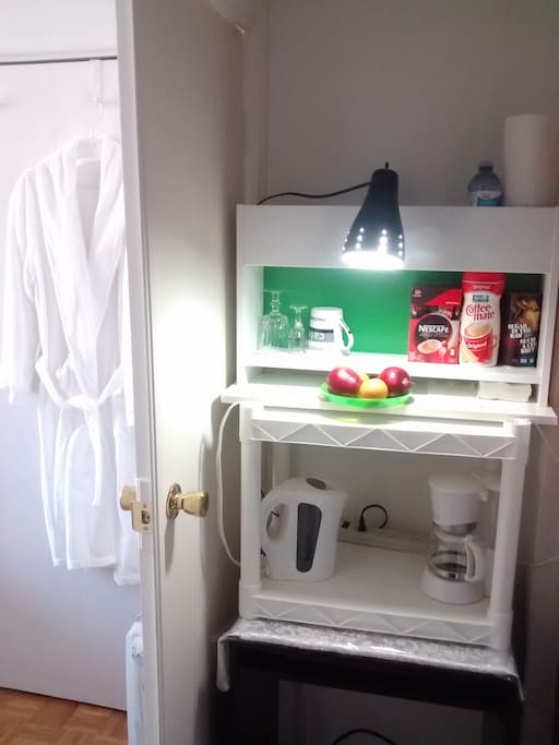 Private mini coffee bar with mini fridge.