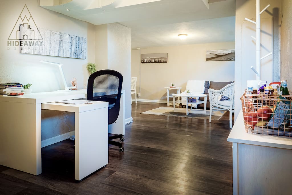 Office desk in the entryway of the suite with a mini-library of Denver and Colorado Guidebooks