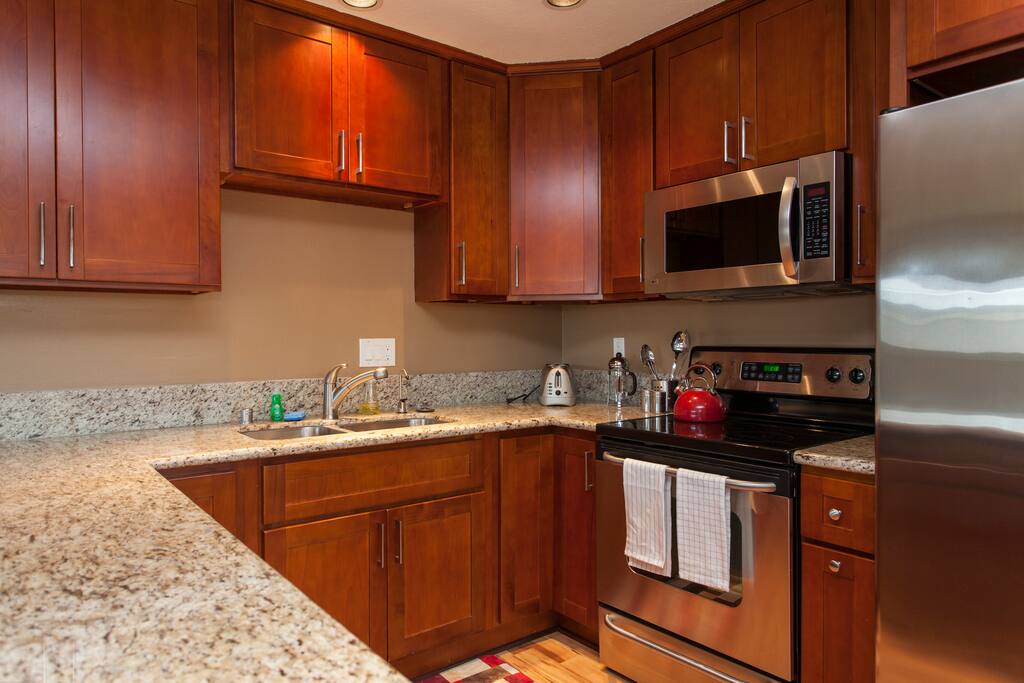 Spacious kitchen with bar seating along the hallway.