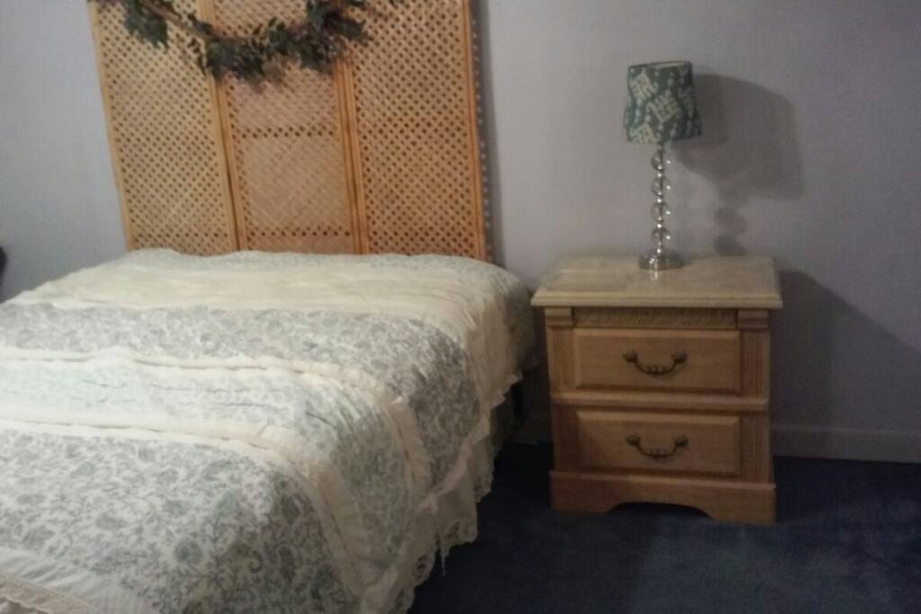 Queen bed and bedside table