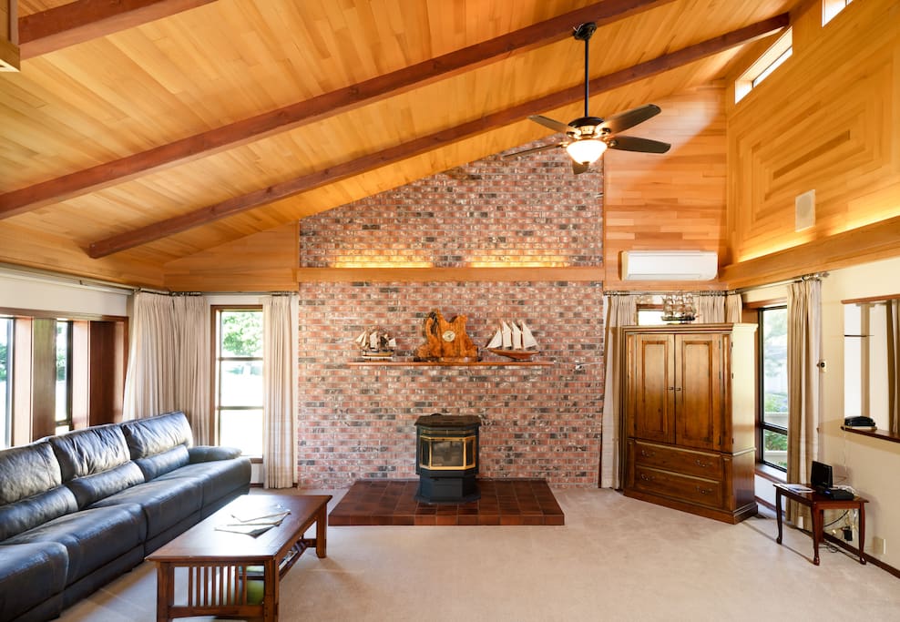 The stone wall in the living room is custom decorated and includes a fireplace. There is also a TV center equipped with a big screen tv and satellite.