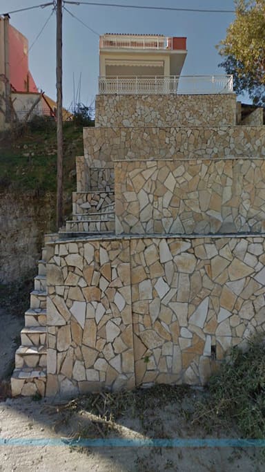 Stairs up to house from street below.