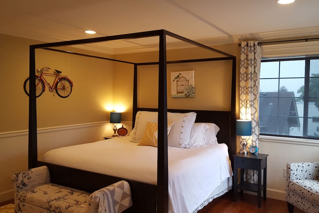 Master bedroom shown with summer coverlet, solar roller shade and new curtains