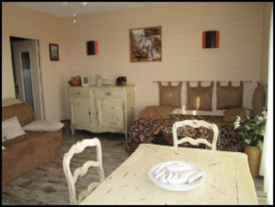 Dining and living room, with french doors leading to balcony with view.