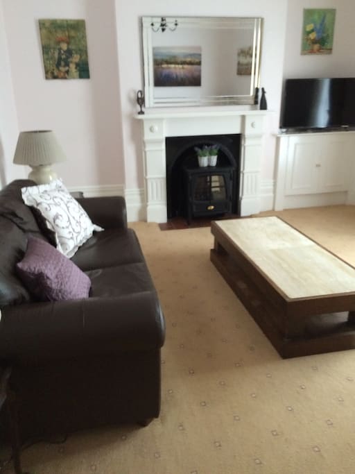 Comfy, airy and spacious sitting room with wide screen TV. French doors lead to pretty front garden.