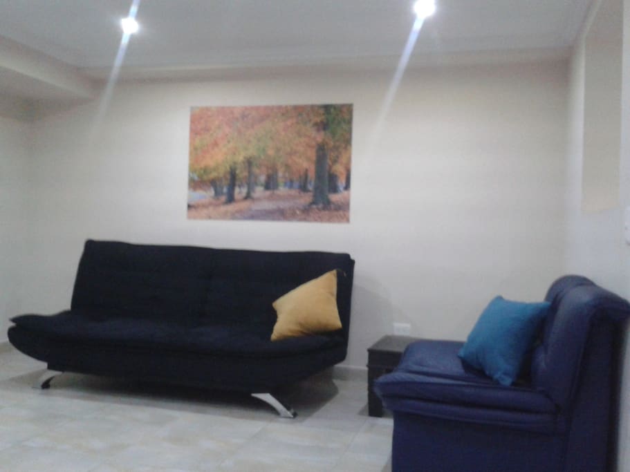 Living area with comfortable sofa and air conditioning