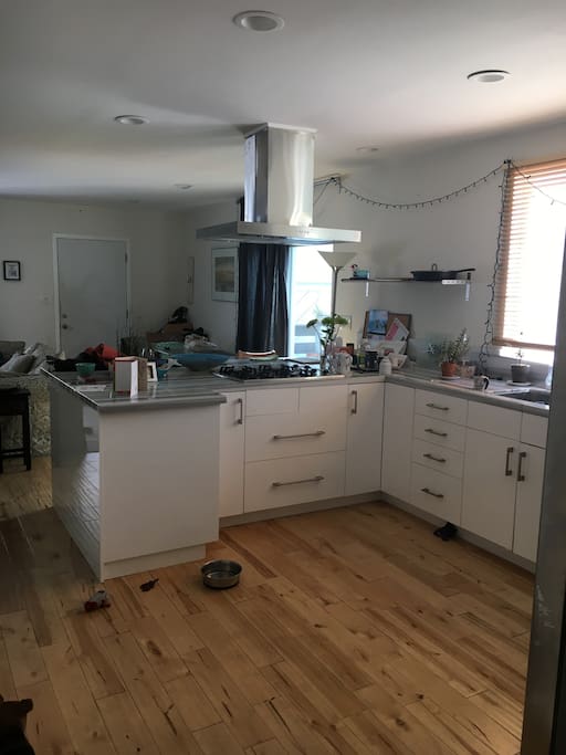 airy kitchen has marble countertop, stainless steel appliances, all cookware - a cook's dream and great for hosting