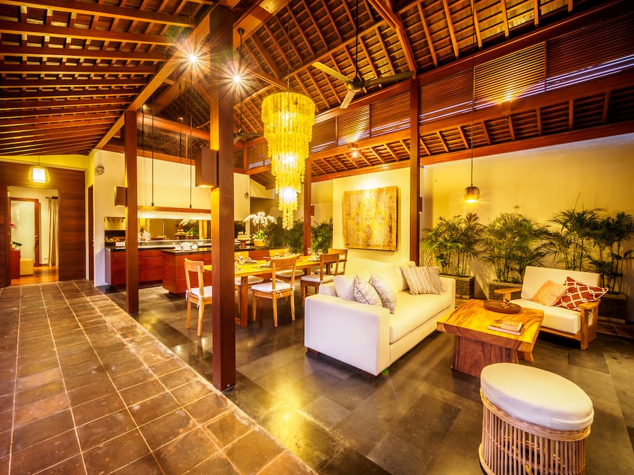 Cozy open living and dining room with expose wooden roof completed with kitchen
