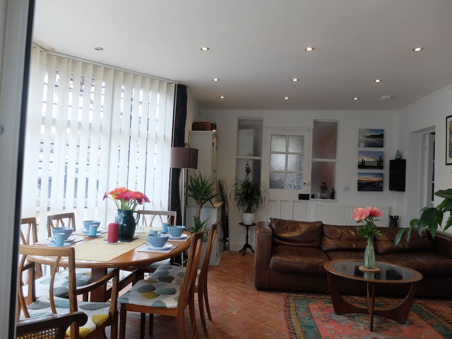 The summer room includes sitting area and dining area and leads directly onto the patio in the garden