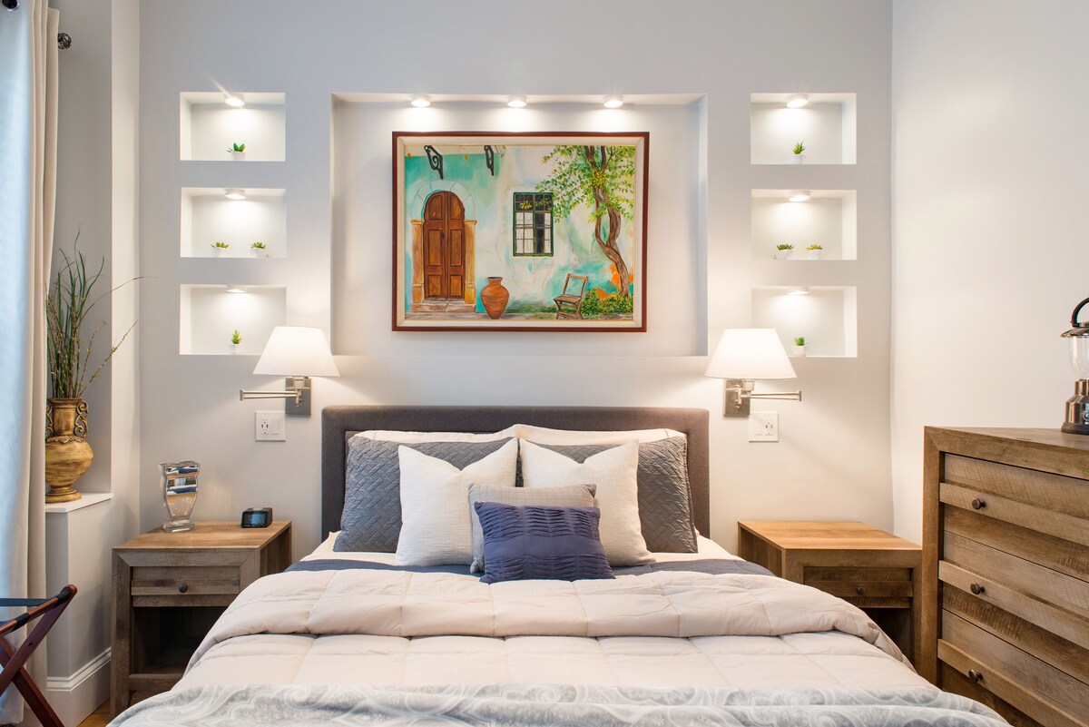Stylish Modern Bedroom with a new queen size foam bed, his and hers reading lights, 3-way wall sconces and USB outlets