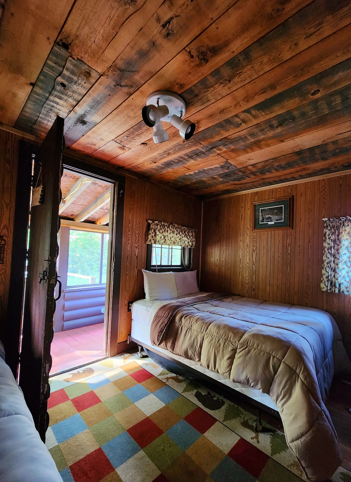 Cozy bedroom leads to the screened in sitting porch.