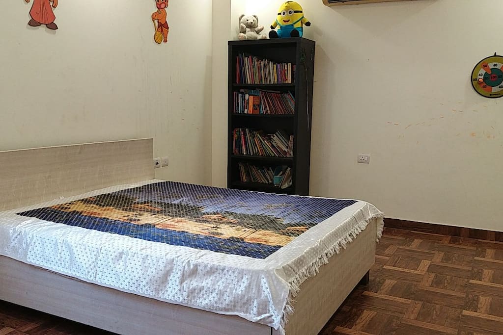 Your spacious bedroom with books on one side!
