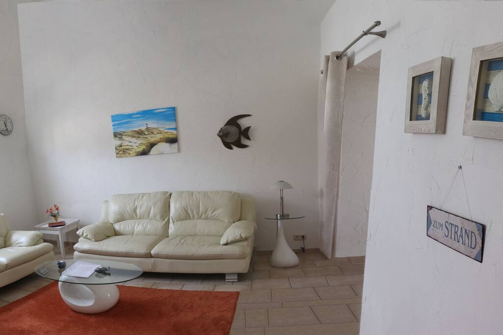 Living room with leather couch and flat TV