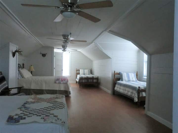 Upper room area.  Has 2 queen size beds, 2 twin beds, and a half bath.