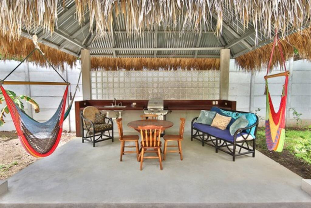 Rancho with BBQ grill, hammocks, couch, sink, bar, table and chairs.