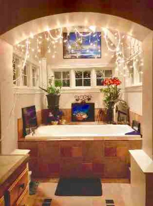 This is the bathroom vanity sink
and tub area. The enclosed toilet and a stand up shower area is to the right. See other photos. Amenities Shared with host).