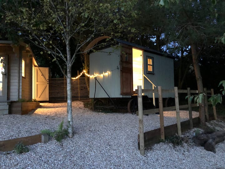 The Shepherds Hut at night with the shower room to the left