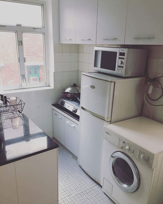 Kitchen, fridge, freezer, washing machine that also dries, grill, gas stove top