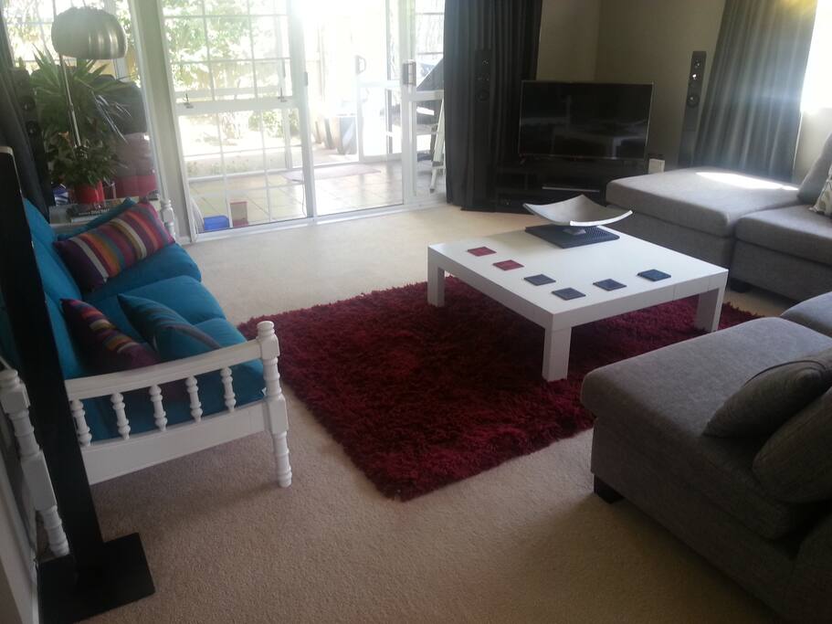 Large lounge with adjacent conservatory (with bean-bags and desk).